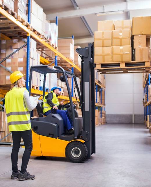 Young warehouse workers working together. Young warehouse workers working together.